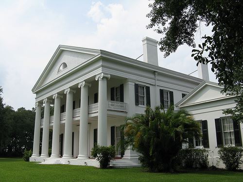 Madewood Plantation House, a white, two story house with Corinthian pillars